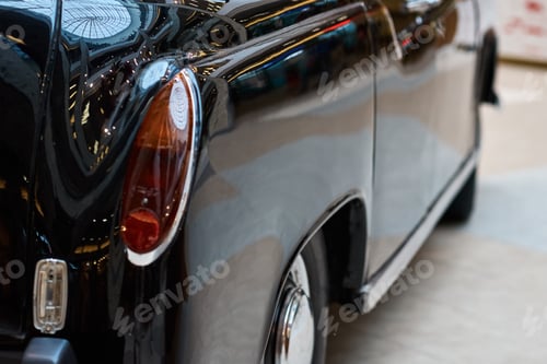 Preview: Closeup of a black vintage car. Back view part of retro car