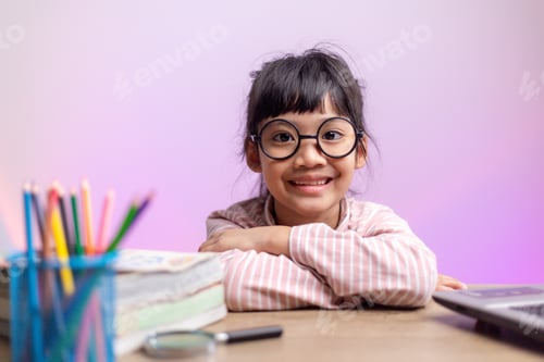 Preview: Asian girl sitting and studying at home on a laptop to study from home during Covid-19