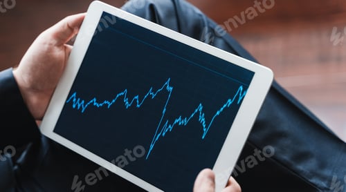 Preview: Businessman, investor,trader analyzing,looking at chart of stock prices in tablet. CEO,general manag