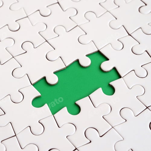 Preview: Close-up texture of a white jigsaw puzzle in assembled state with missing elements formi