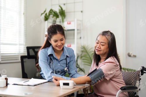 Preview: A nurse checks a senior patient's blood pressure during a friendly consultation.
