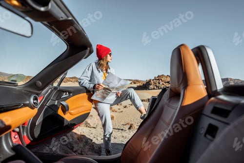 Preview: Woman traveling by cabriolet car on the desert valley