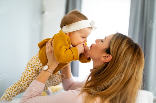 Preview: Woman Holding a Baby in an Indoor Setting