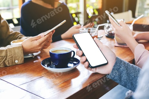 Preview: People holding and using black mobile phone with blank desktop screen together in cafe