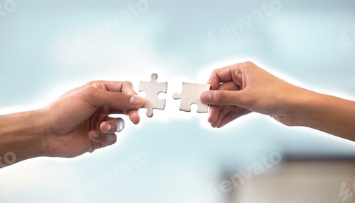 Preview: Cropped shot of two unrecognizable businesspeople holding up two puzzle pieces in the office