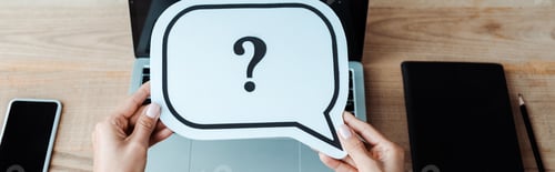 Preview: panoramic shot of woman holding speech bubble with question mark near laptop with blank screen
