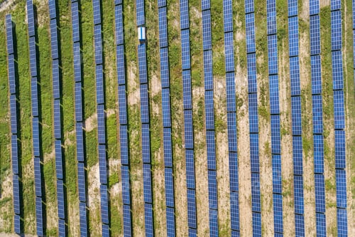 Preview: Aerial view of solar power plant on green field.