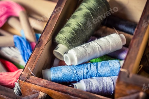 Preview: Closeup of tailor's wooden box with various threads
