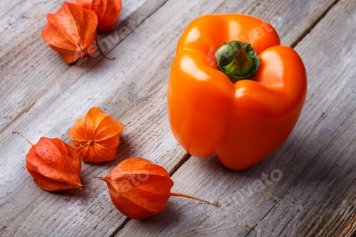 Preview: orange pepper and physalis on a wooden background