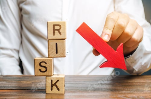 Preview: Wooden blocks with the word Risk and a down arrow