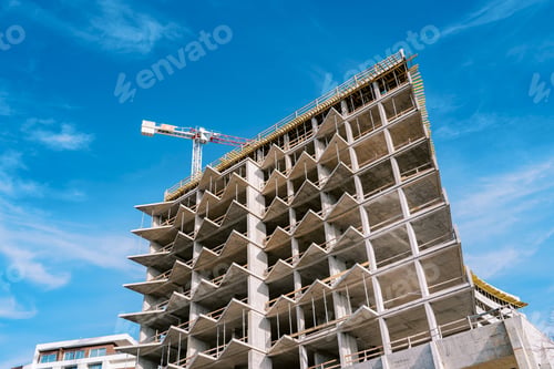 Preview: High tower crane builds a multi-storey building with balconies
