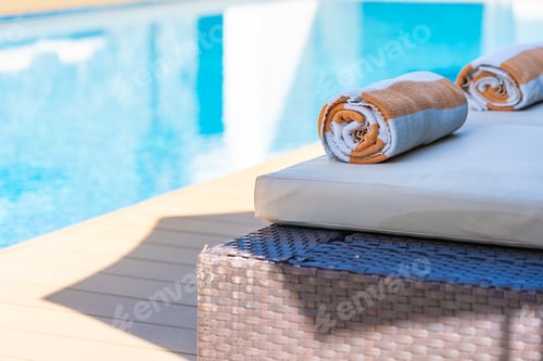 Preview: Towel on bed around swimming pool in hotel resort