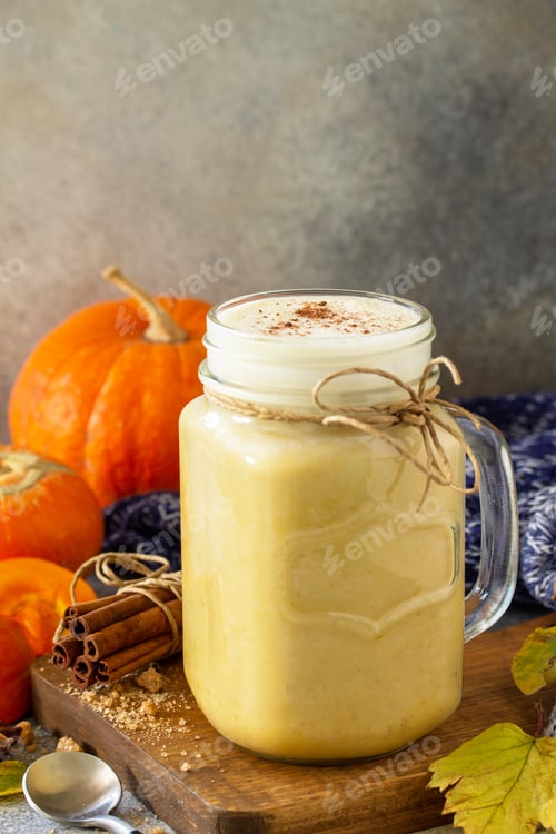 Preview: Pumpkin spiced latte or coffee in glass.