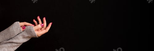 Preview: Hand with pink nails on black background