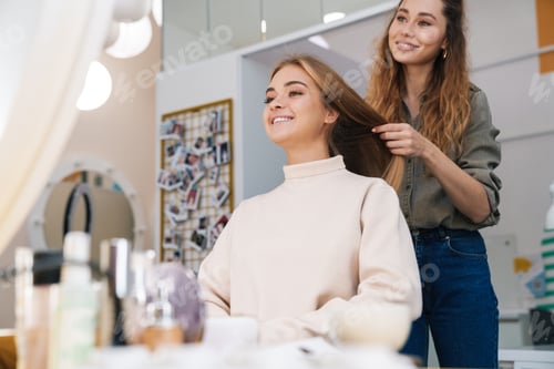 Preview: Woman Smiling While Getting Her Hair Styled
