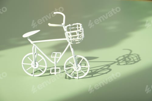Preview: Decorative white bycicle on green background with hard shadows. Sustainable lifestyle concept