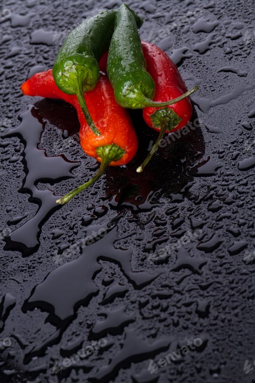 Preview: Multi-coloured peppers with tails in camera.