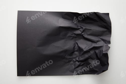 Preview: top view of empty crumpled black paper on white background