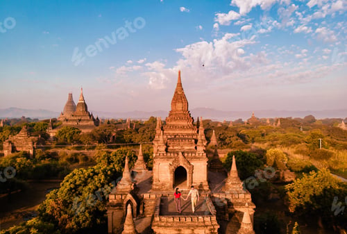 Preview: A temple surrounded by trees under a blue sky with fluffy clouds
