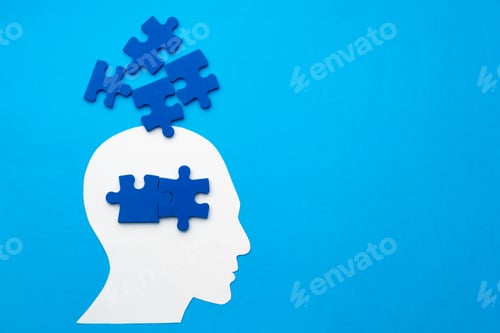 Preview: Papercut head with jigsaw puzzle pieces on blue background