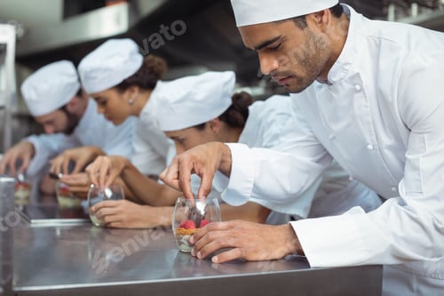 Preview: Chefs finishing dessert in glass at restaurant