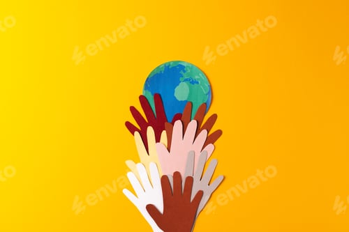 Preview: Paper cut out of multi coloured hands and globe with copy space on yellow background