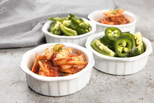 Preview: Bowls of kimchi and peppers.