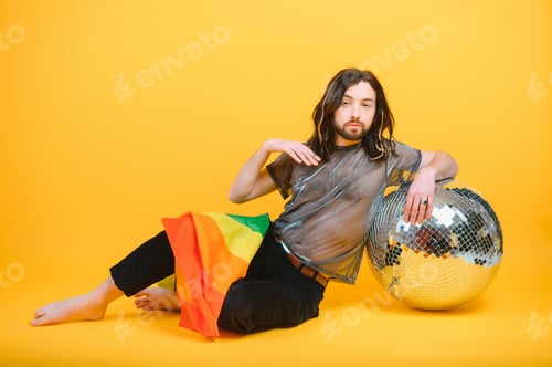 Preview: Young gay man is standing in the studio and posing for a camera.