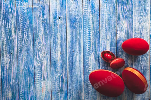 Preview: Easter red decorative eggs on a light blue wooden surface