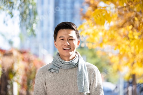 Preview: Portrait of smiling young Chinese man in autumn