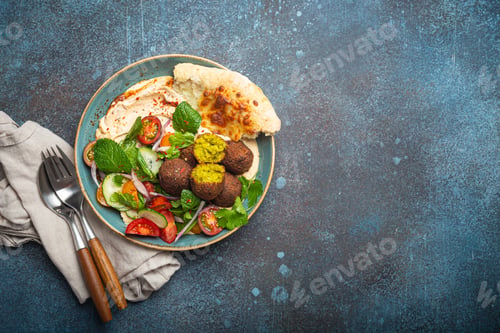 Preview: Middle Eastern Arab meal with fried falafel, hummus, vegetables salad, pita bread