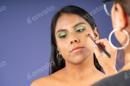 Preview: Applying powder with a brush on a young woman