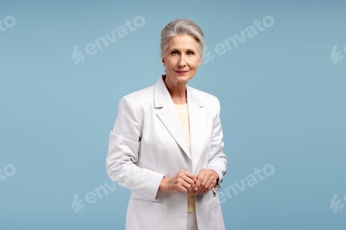 Preview: Elegant Senior Woman Poses in White Suit Jacket