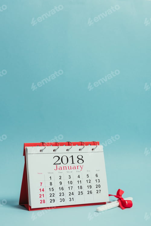 Preview: close up view of calendar and pregnancy test with ribbon isolated on blue