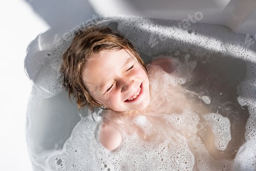 Preview: Eight year old boy in a bathtub, having a bath