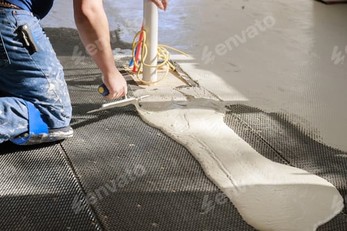 Preview: Floor preparation before pouring concrete in troweling adhesive onto a concrete floor