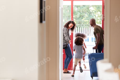Preview: Family Standing By Front Door With Suitcase About To Leave For Vacation