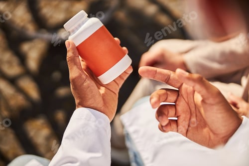 Preview: Male hands holding a jar of pills