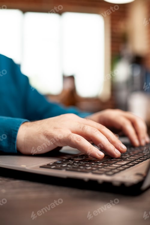 Preview: Closeup of person typing on laptop