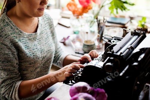 Preview: Woman typing typewriter on the table