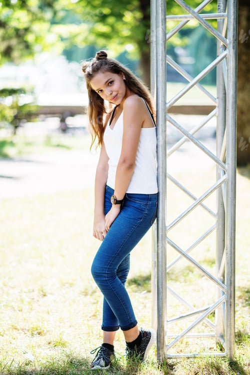 Preview: Close-up portrait of a fantastic young model girl posing in the park on a sunny day.