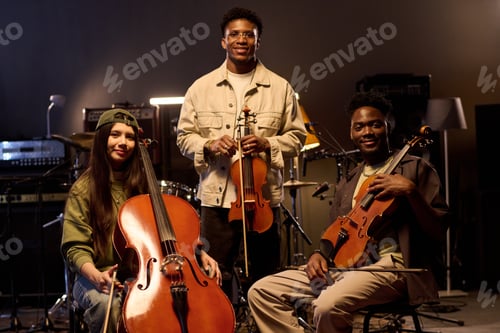 Preview: Multiethnic Young Adult Musicians Posing with String Instruments in Studio