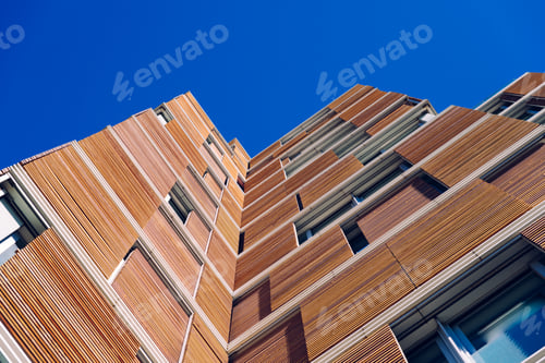 Preview: facade of a modern building clad in ecological wood concept of sustainable construction