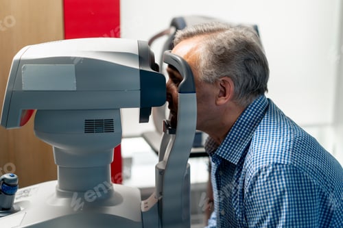 Preview: in an ophthalmology clinic elderly patient is diagnosed with a vision test using a machine