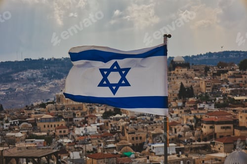 Preview: Close-up shot of the flag of Israel with the old city in background