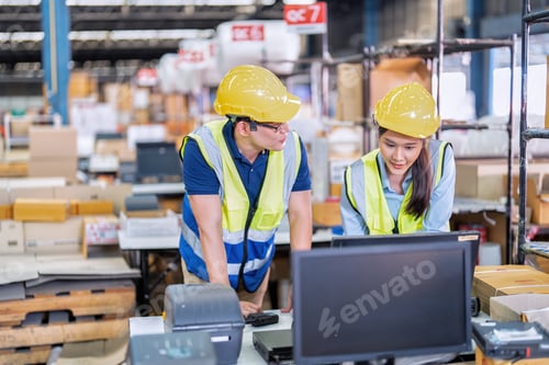 Preview: Staff working in large depot storage warehouse trainee check packing box and scan at cashier counter