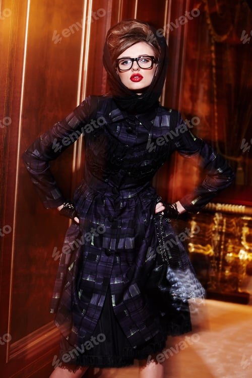 Preview: A woman in a black dress posing.