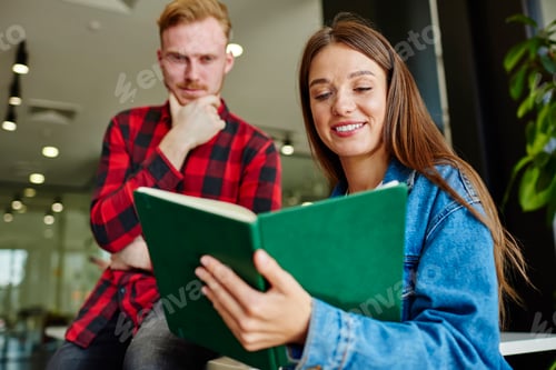 Preview: Caucasian guys 20 years old checking notes from knowledge textbook