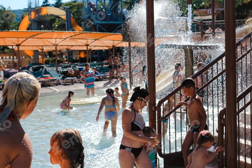 Preview: People having fun on water slides at aquapark. Summertime, vacation, childhood, holidays concept. N
