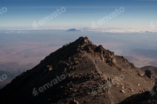 Preview: Hikers walking up the rocky path of mount meru in tanzania, africa